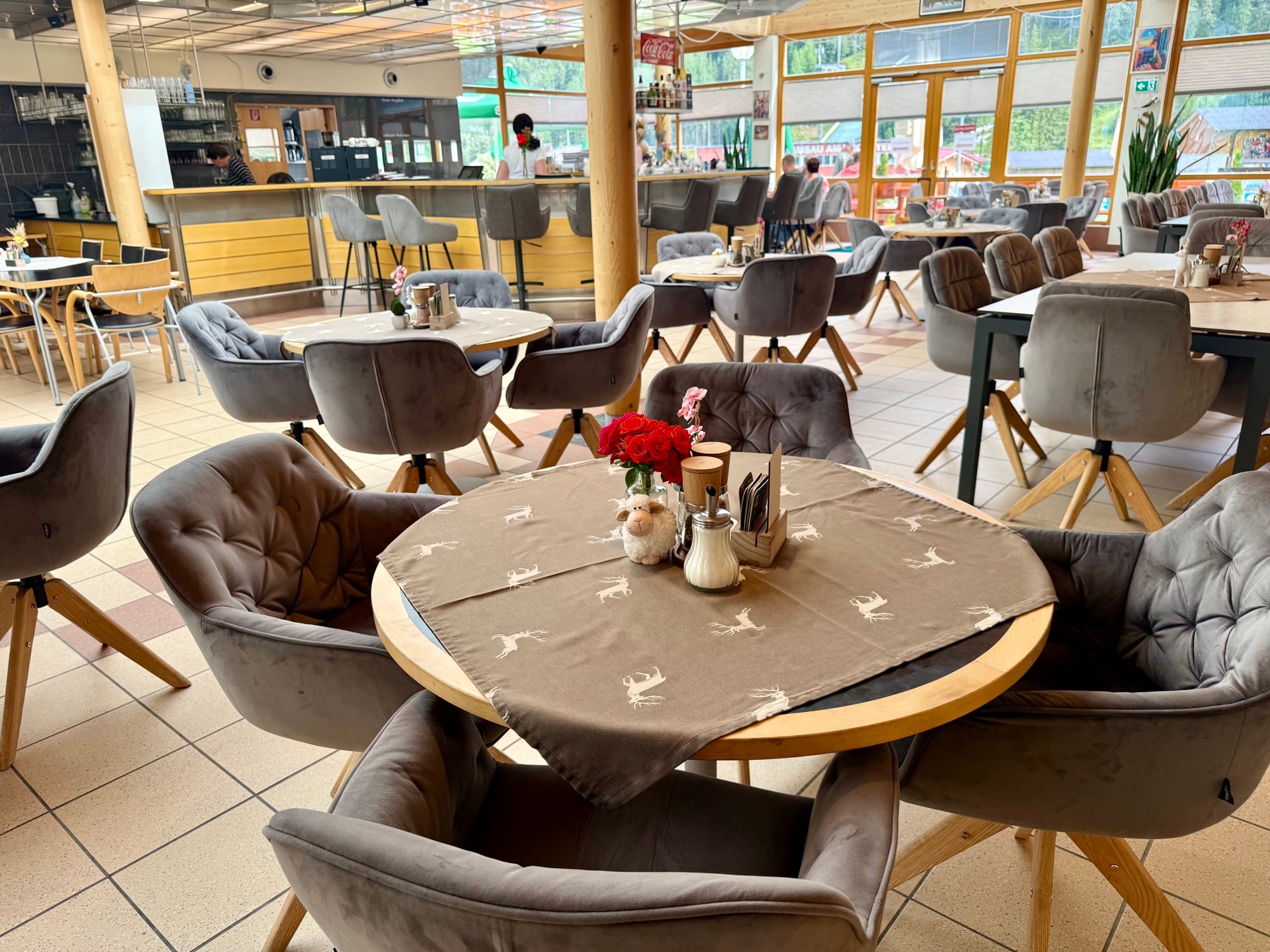Warmly lit restaurant dining room with wooden tables and soft lighting (placeholder image)